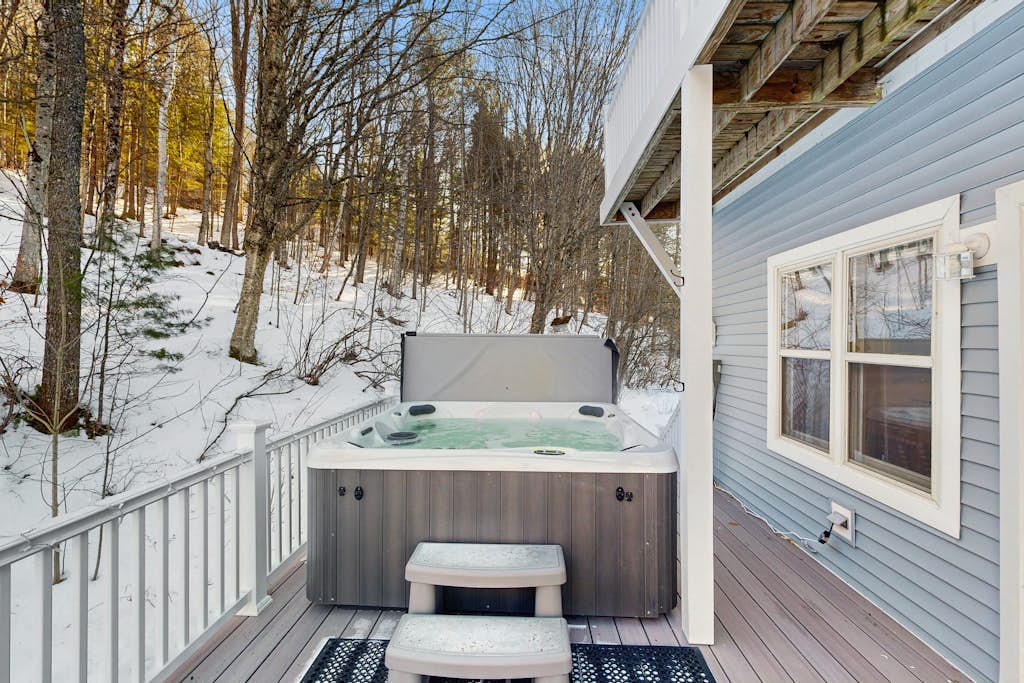 Private hot tub on the deck overlooking the snowy woods