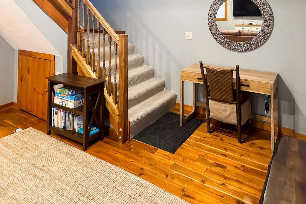 Entry nook with desk, bookshelf, and games