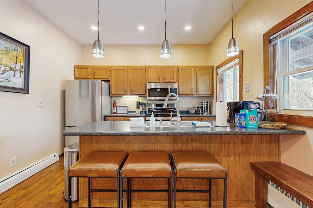 Full kitchen with breakfast bar and stools