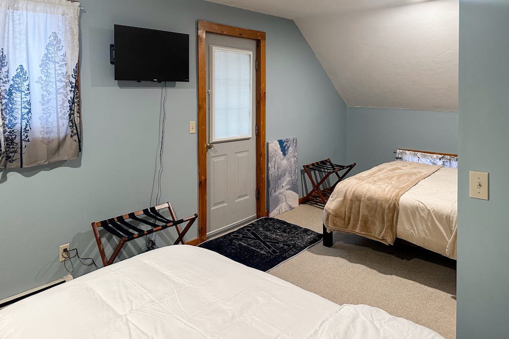 Bedroom with two beds and deck door