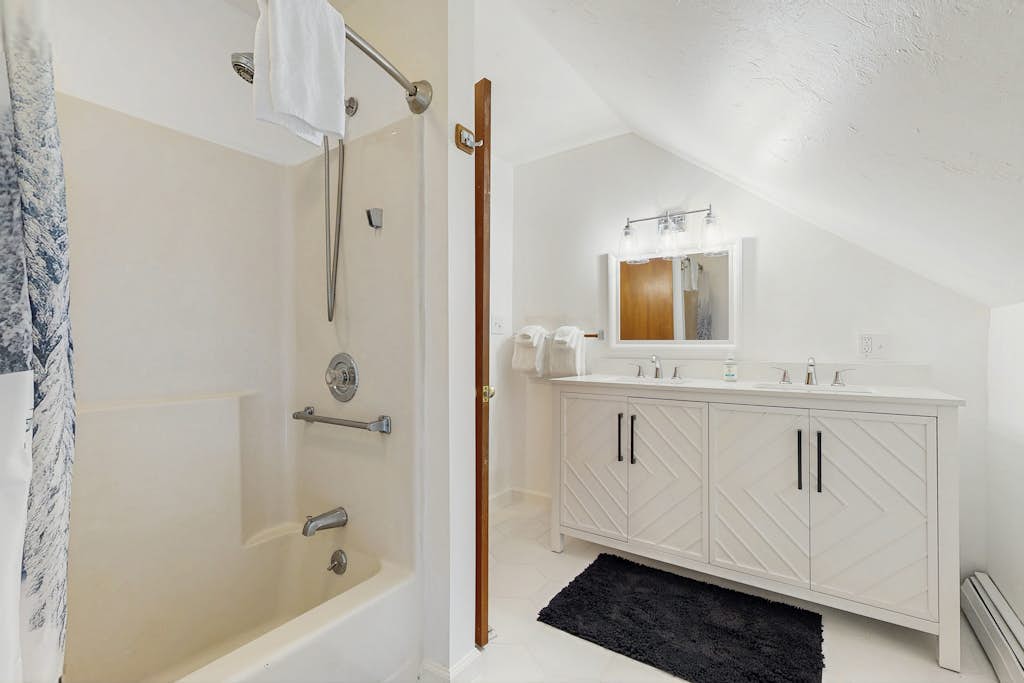 Bathroom with double chevron vanity and tub