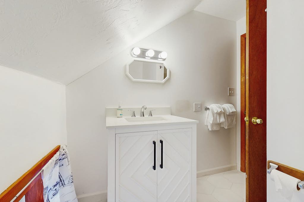 Bathroom with white vanity and tiled floor