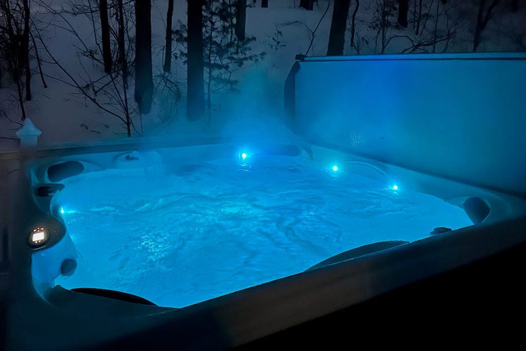 Hot tub glowing blue in the evening