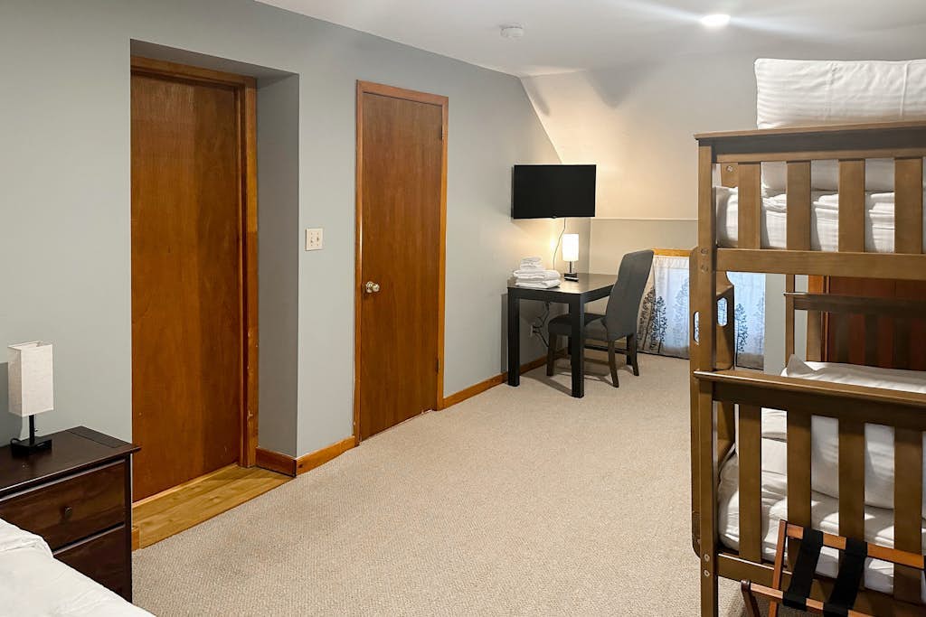 Bedroom with bunk beds and a work desk